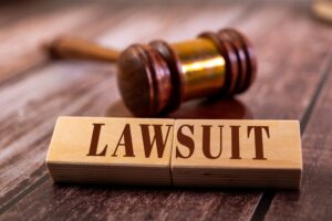 Two wooden blocks with the word "LAWSUIT"