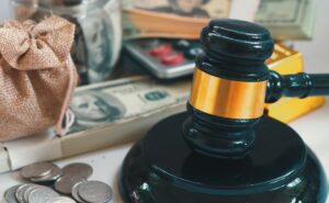 Judge's Gavel and Dollar bills and calculator in background